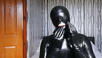 Latex-Clad Submissive Restrained And Silenced In Rubber Bondage